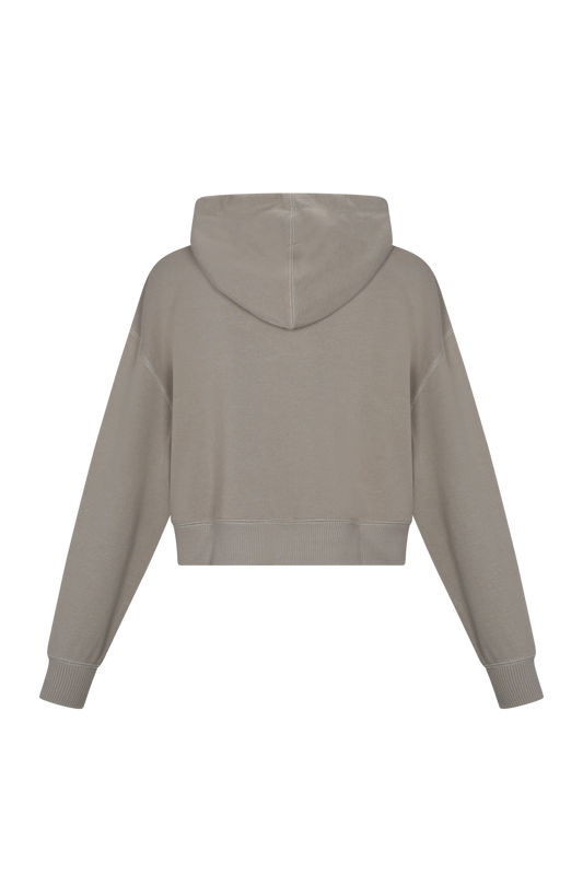 Sudadera cropped parte posterior  en tono gris claro, con capucha,fabricada en algodón pima peruano y cómodo. Ideal para un atuendo casual.